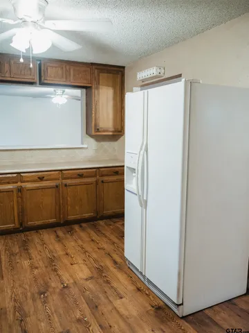 a view of a kitchen with wooden floor and a sink