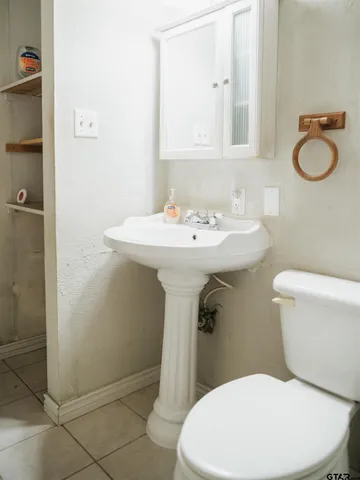 a white toilet sitting next to a bathroom sink