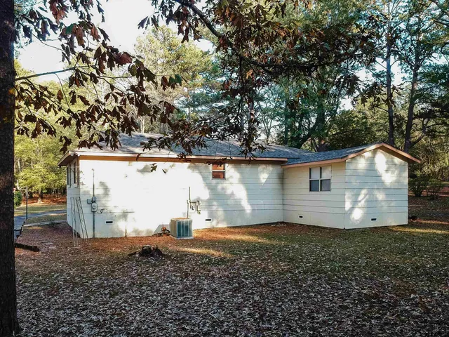 a view of a backyard with a patio and a fireplace