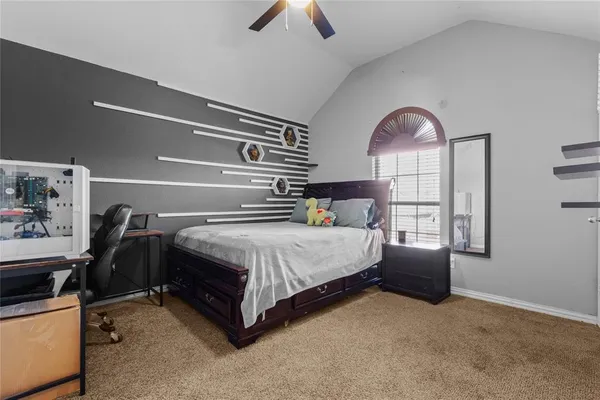 a bedroom with a bed wooden floor and window