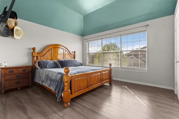 a bed sitting in a bedroom next to a window