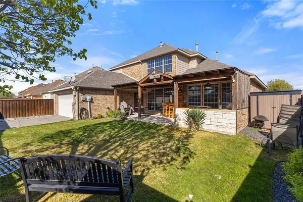 a view of a house with backyard and sitting area