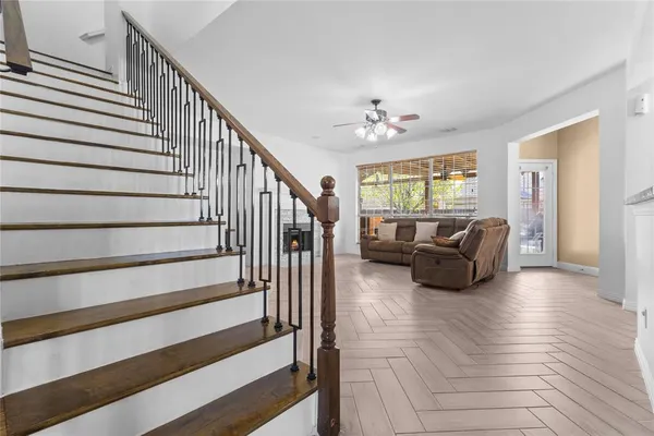 a living room with furniture ceiling fan and a rug