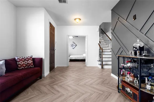 a living room with furniture and a book shelf