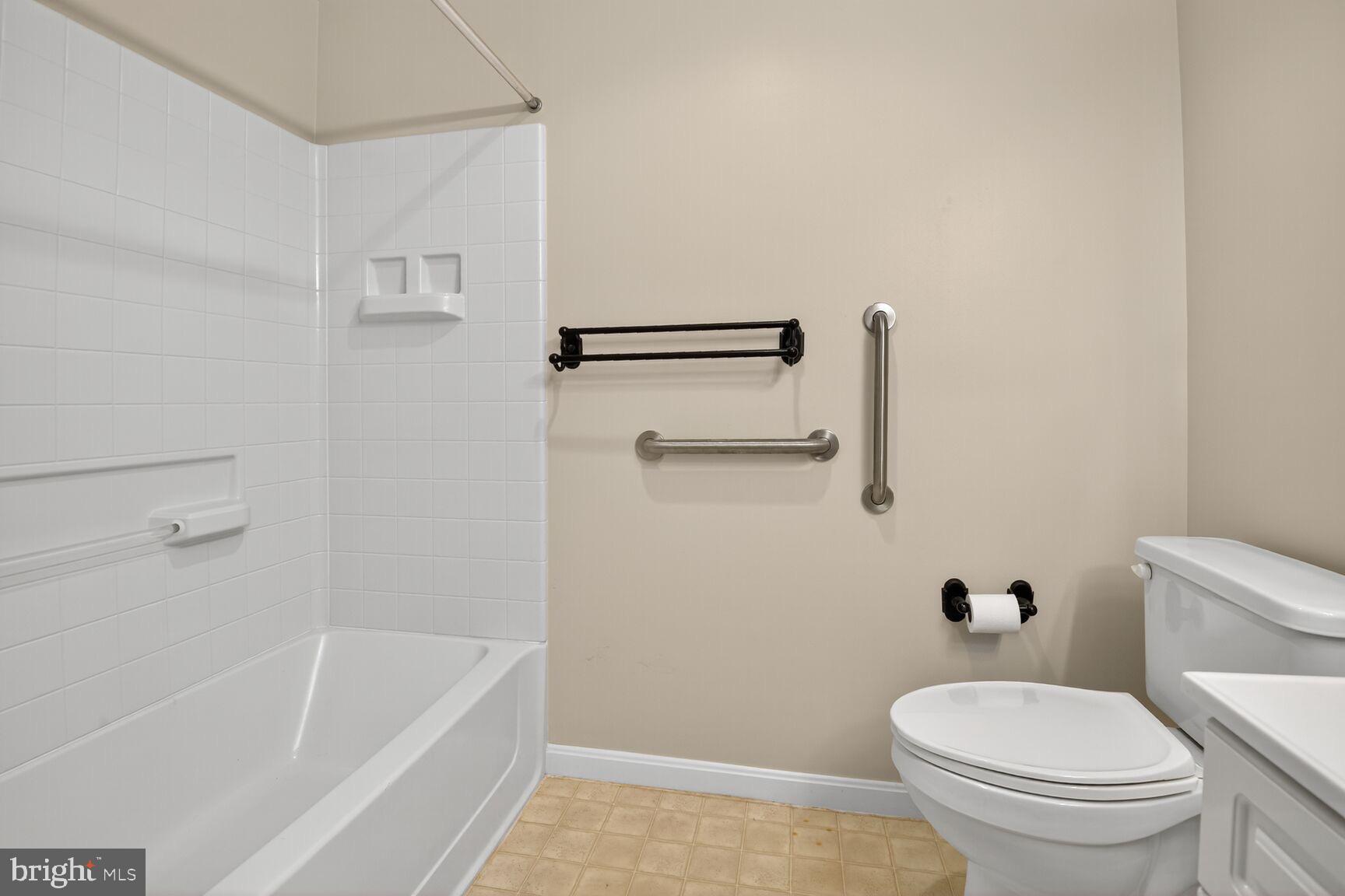 19355 Cypress Ridge Terrace, Unit 503 Leesburg, VA 20176 - Photo 13 of 22 a white toilet sitting next to a bath tub