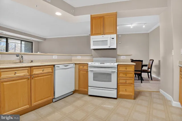 a view of a kitchen with a sink and a refrigerator