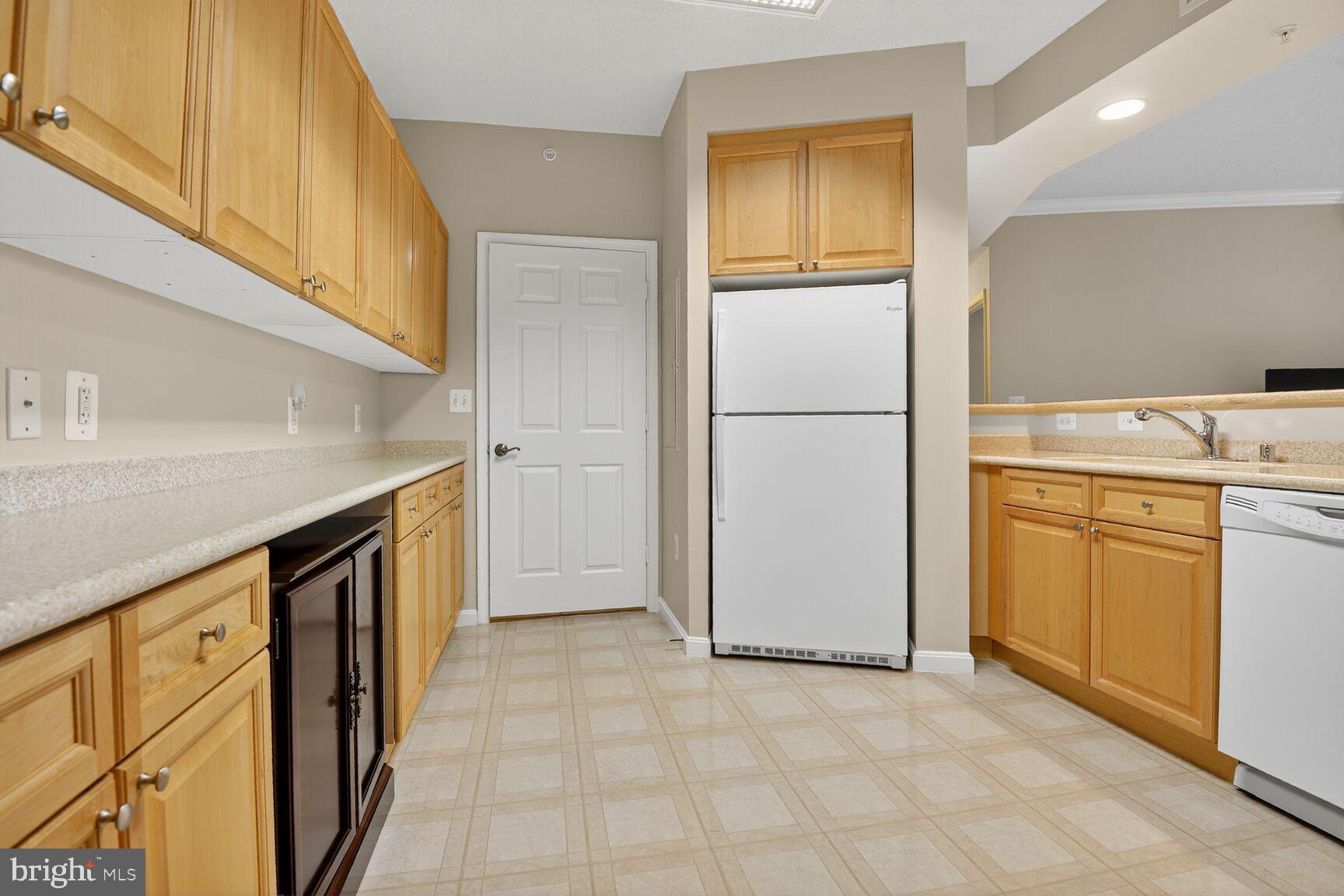 19355 Cypress Ridge Terrace, Unit 503 Leesburg, VA 20176 - Photo 7 of 22 a view of a kitchen with a sink and a refrigerator