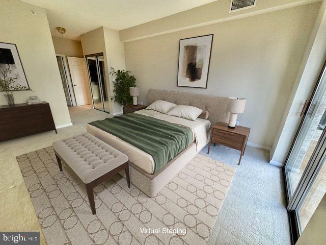 19355 Cypress Ridge Terrace, Unit 503 Leesburg, VA 20176 - Photo 8 of 22 a bedroom with a bed a couch and a large mirror