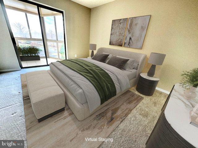 19355 Cypress Ridge Terrace, Unit 503 Leesburg, VA 20176 - Photo 9 of 22 a bedroom with a bed and glass window