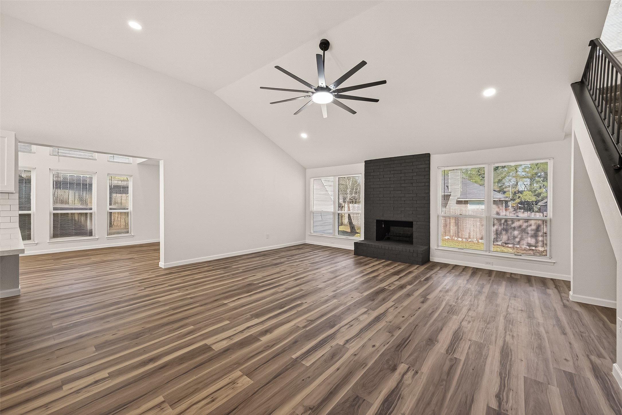 2915 Whispering Springs Drive Spring, TX 77373 - Photo 4 of 36 Spacious open-concept living area with vaulted ceilings, abundant natural light, and luxury vinyl plank flooring throughout.