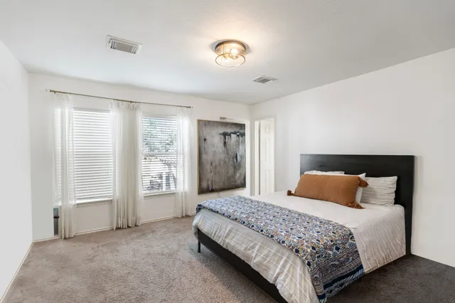 a view of a livingroom and dining room with furniture wooden floor and a chandelier