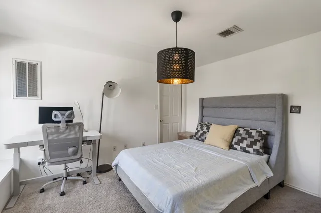 a bedroom with a bed and a mirror