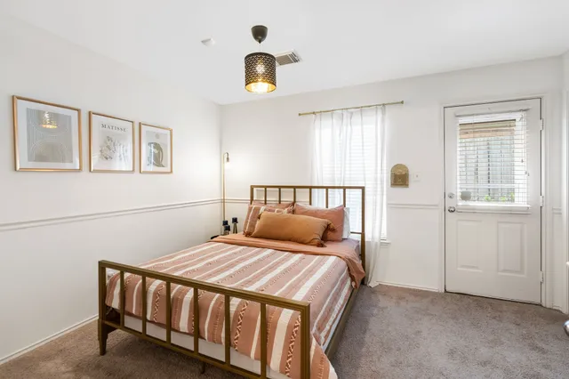 a bedroom with a bed and a chandelier