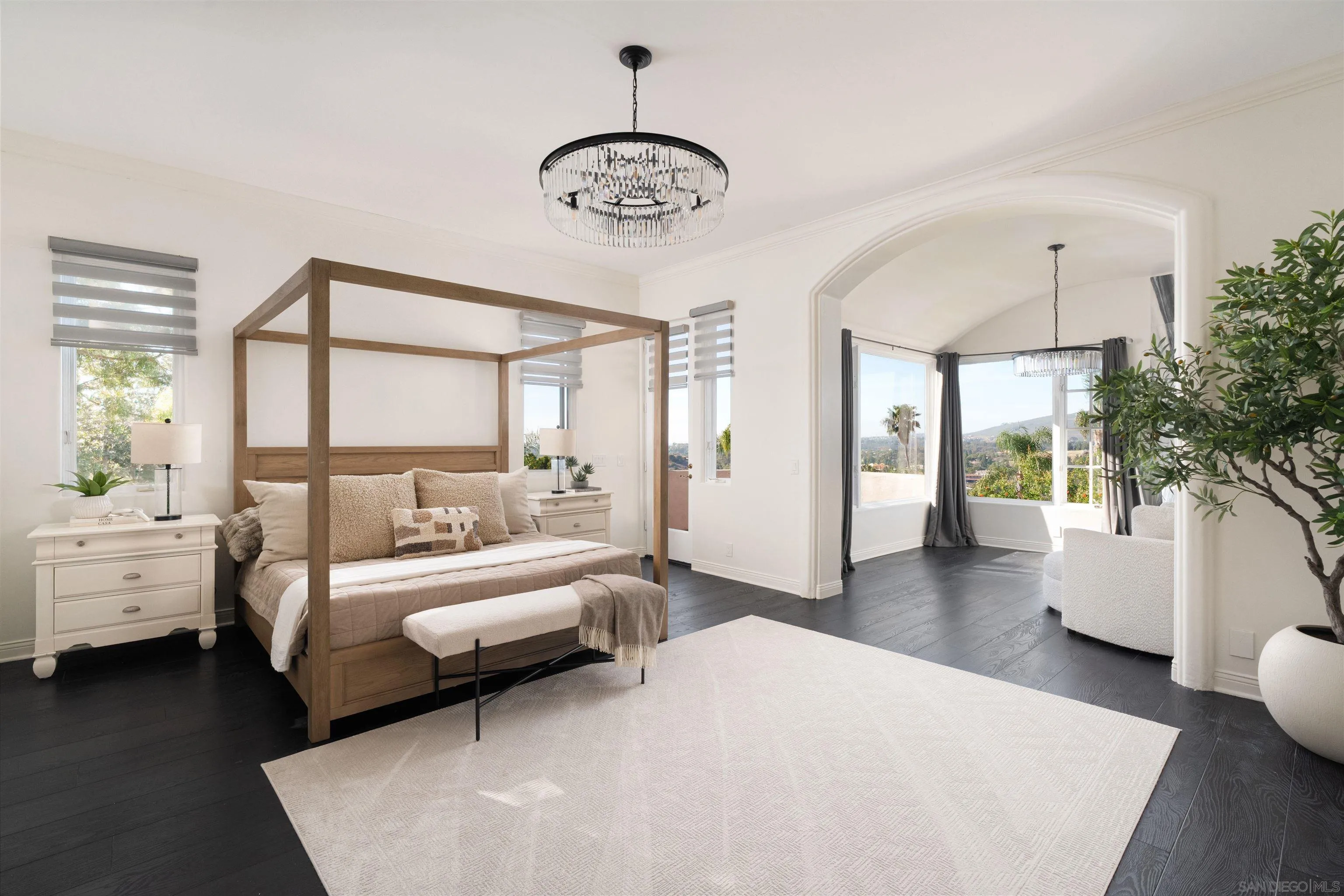 18136 Via Ascenso Rancho Santa Fe, CA 92067 - Photo 15 of 41 a bedroom with a large bed and a chandelier