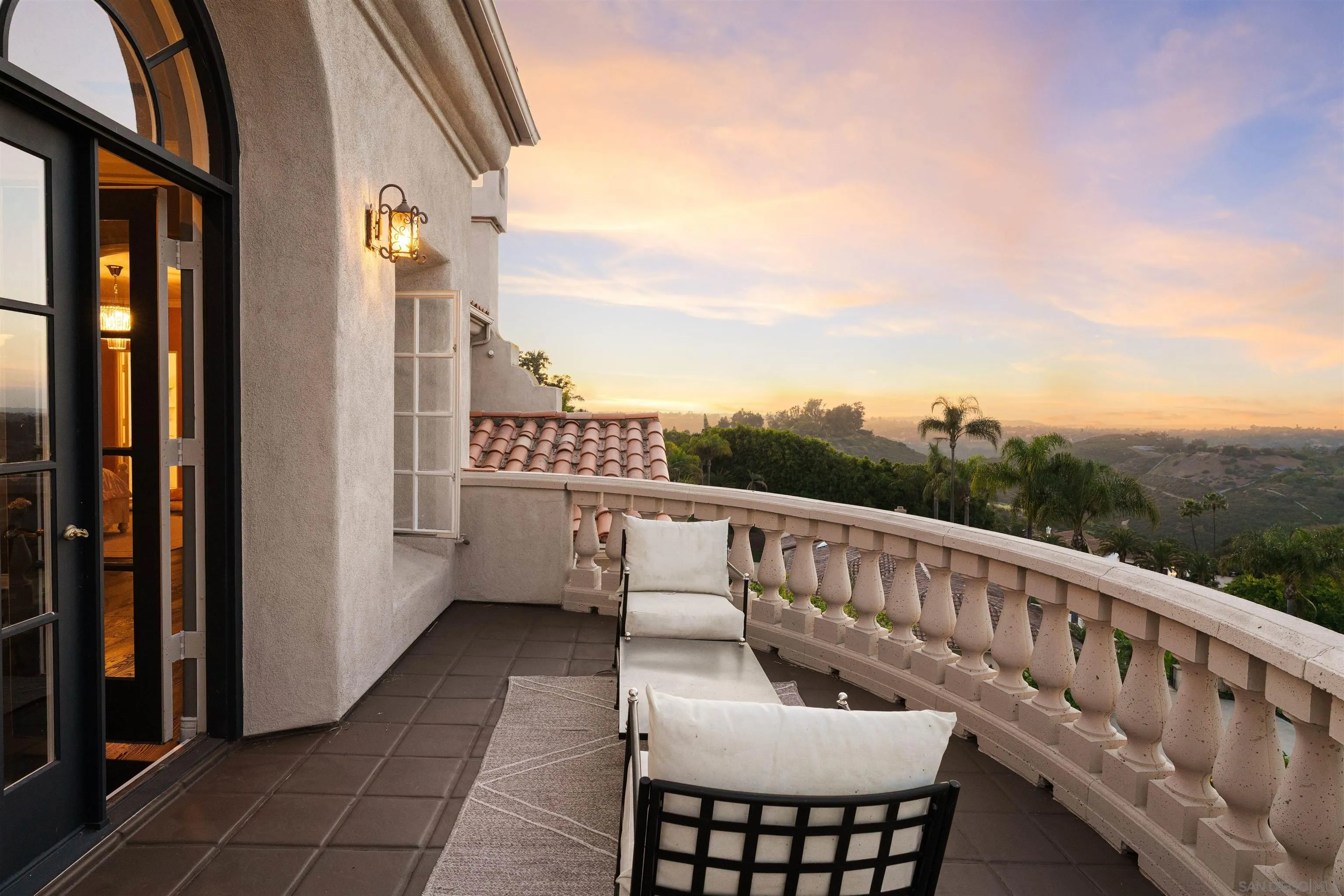 18136 Via Ascenso Rancho Santa Fe, CA 92067 - Photo 36 of 41 a balcony with a table and chairs