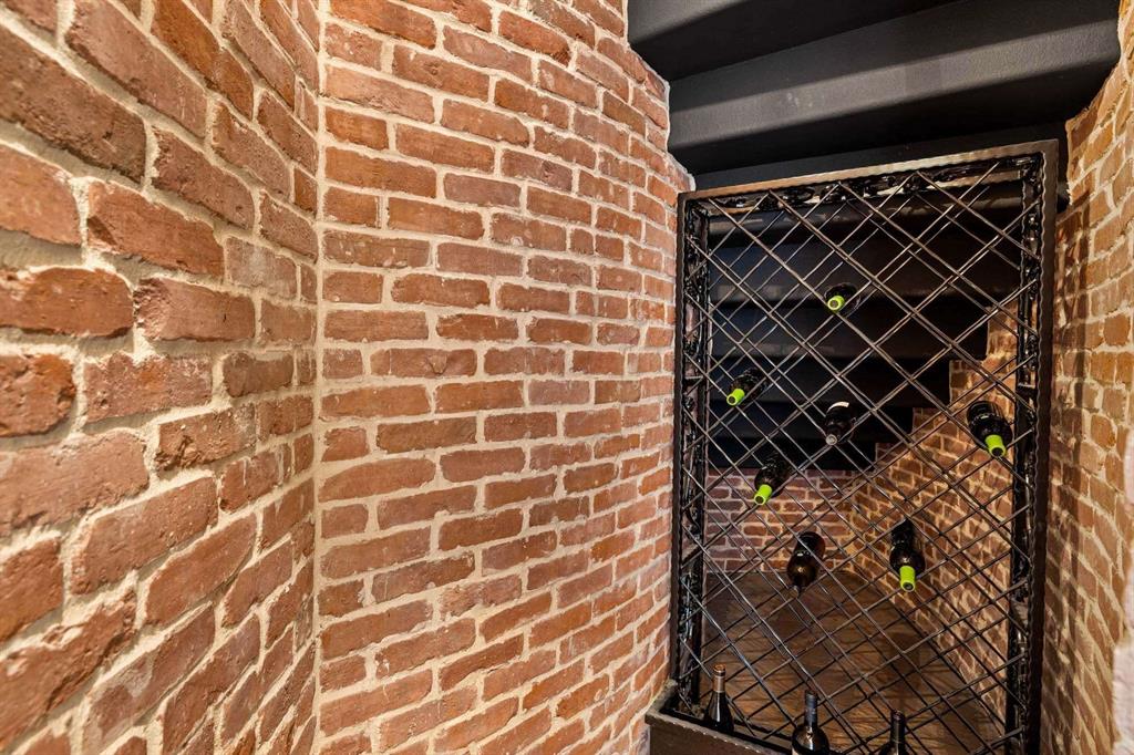 2115 Paradise Rnch Trail McKinney, TX 75071 - Photo 30 of 40 Exposed brick walls surround a built-in metal wine rack with diamond-patterned storage