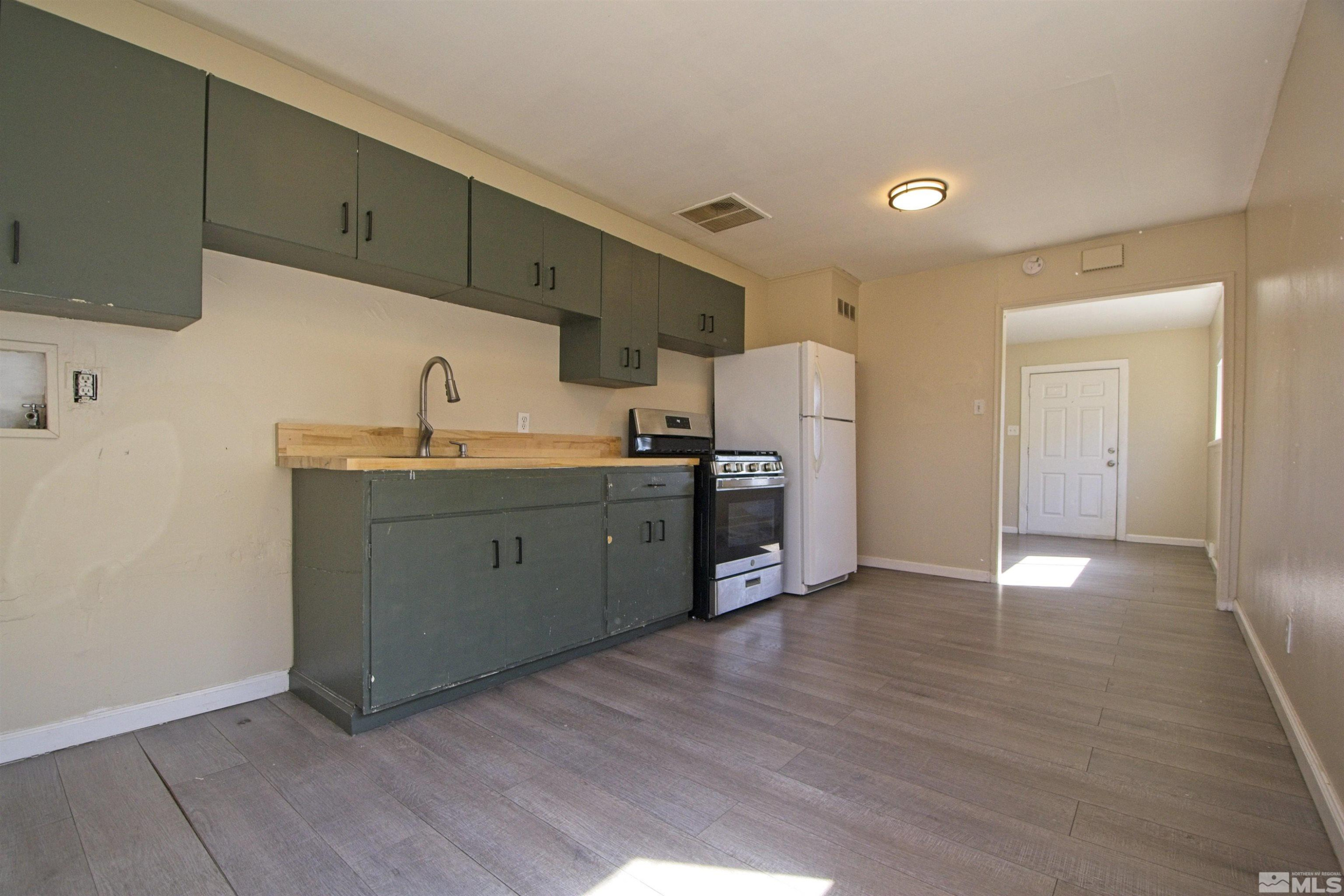 2516 D Street Sparks, NV 89431 - Photo 3 of 9 a kitchen with stainless steel appliances a sink cabinets and wooden floor