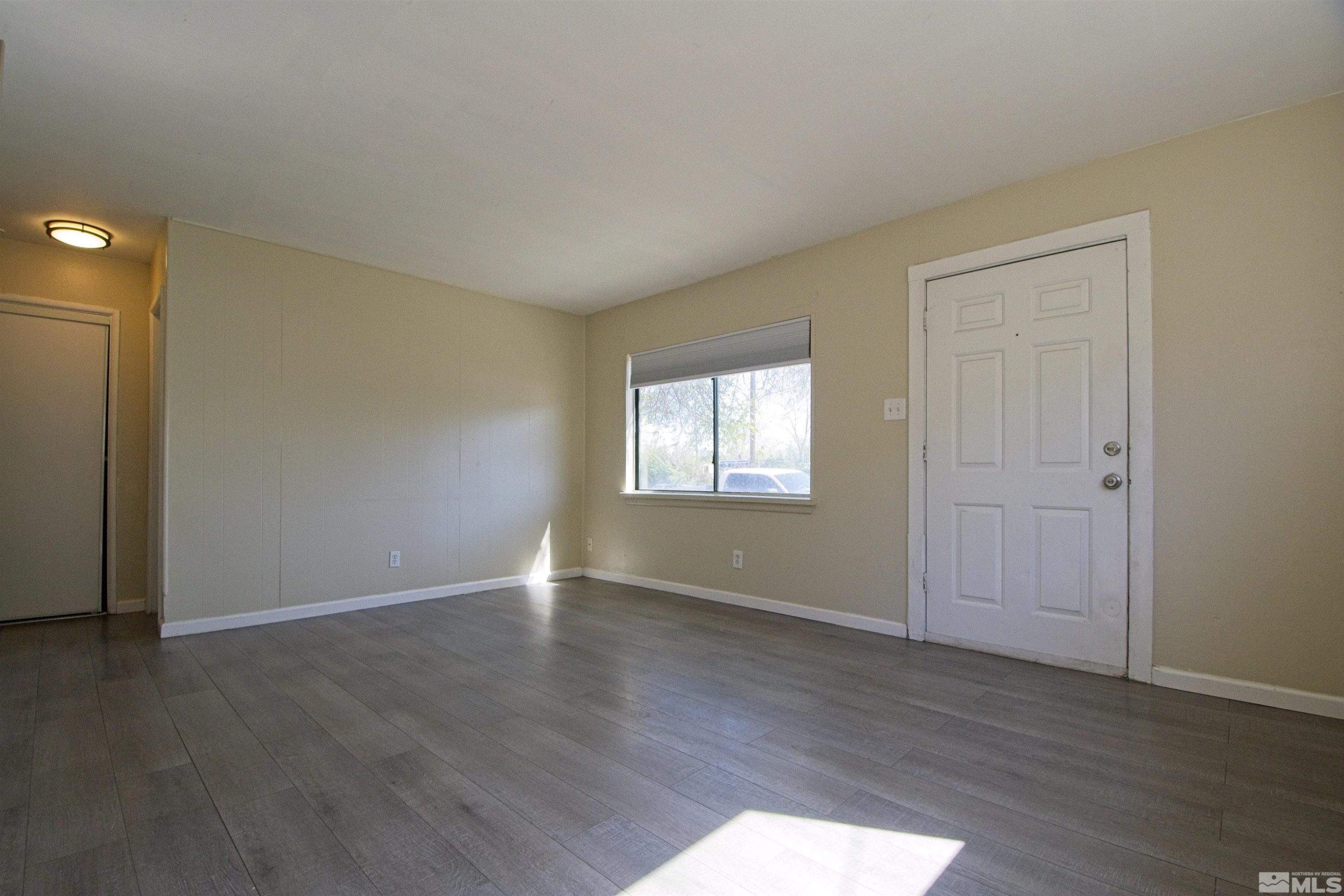 2516 D Street Sparks, NV 89431 - Photo 5 of 9 an empty room with wooden floor and windows