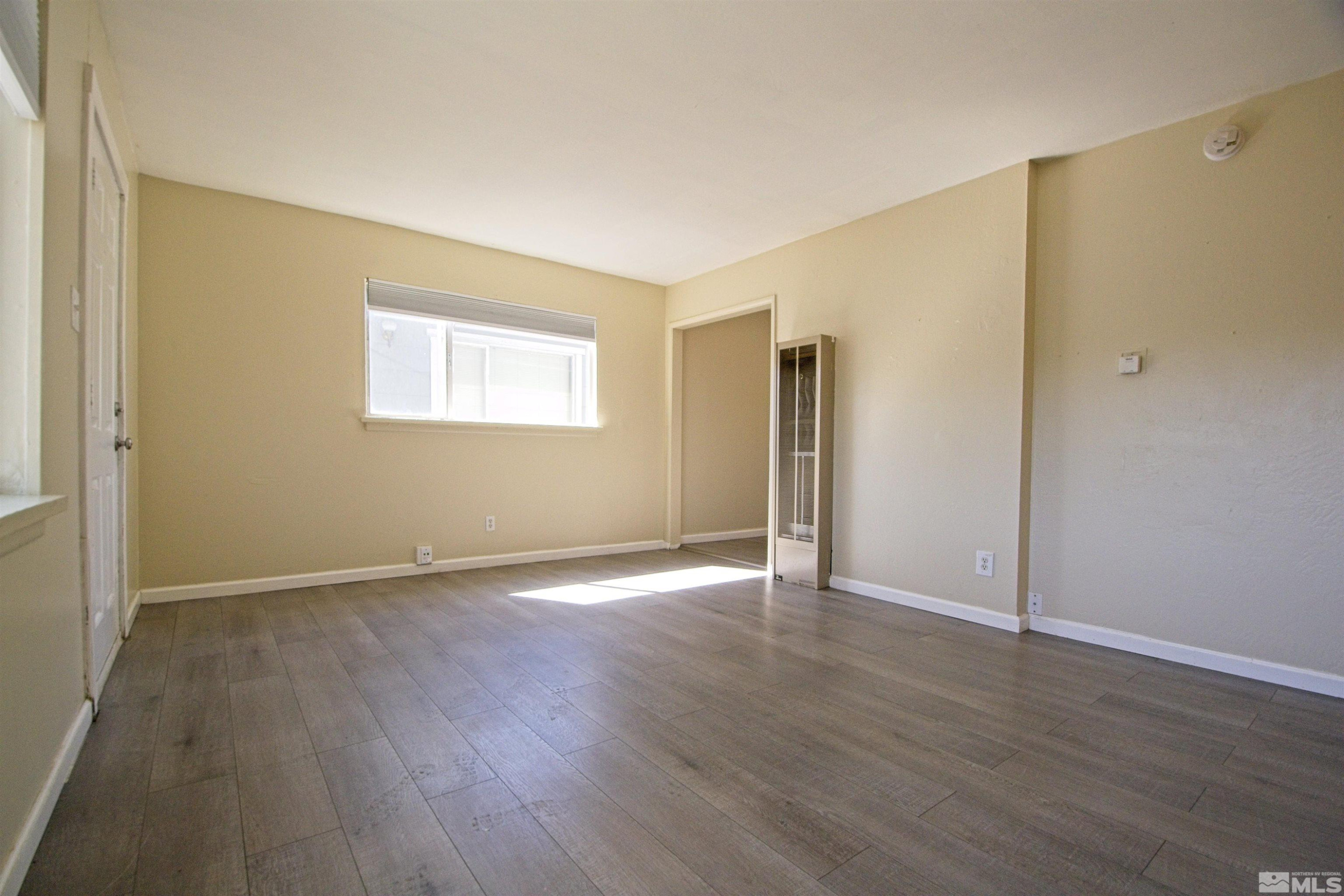 2516 D Street Sparks, NV 89431 - Photo 6 of 9 an empty room with wooden floor and a window
