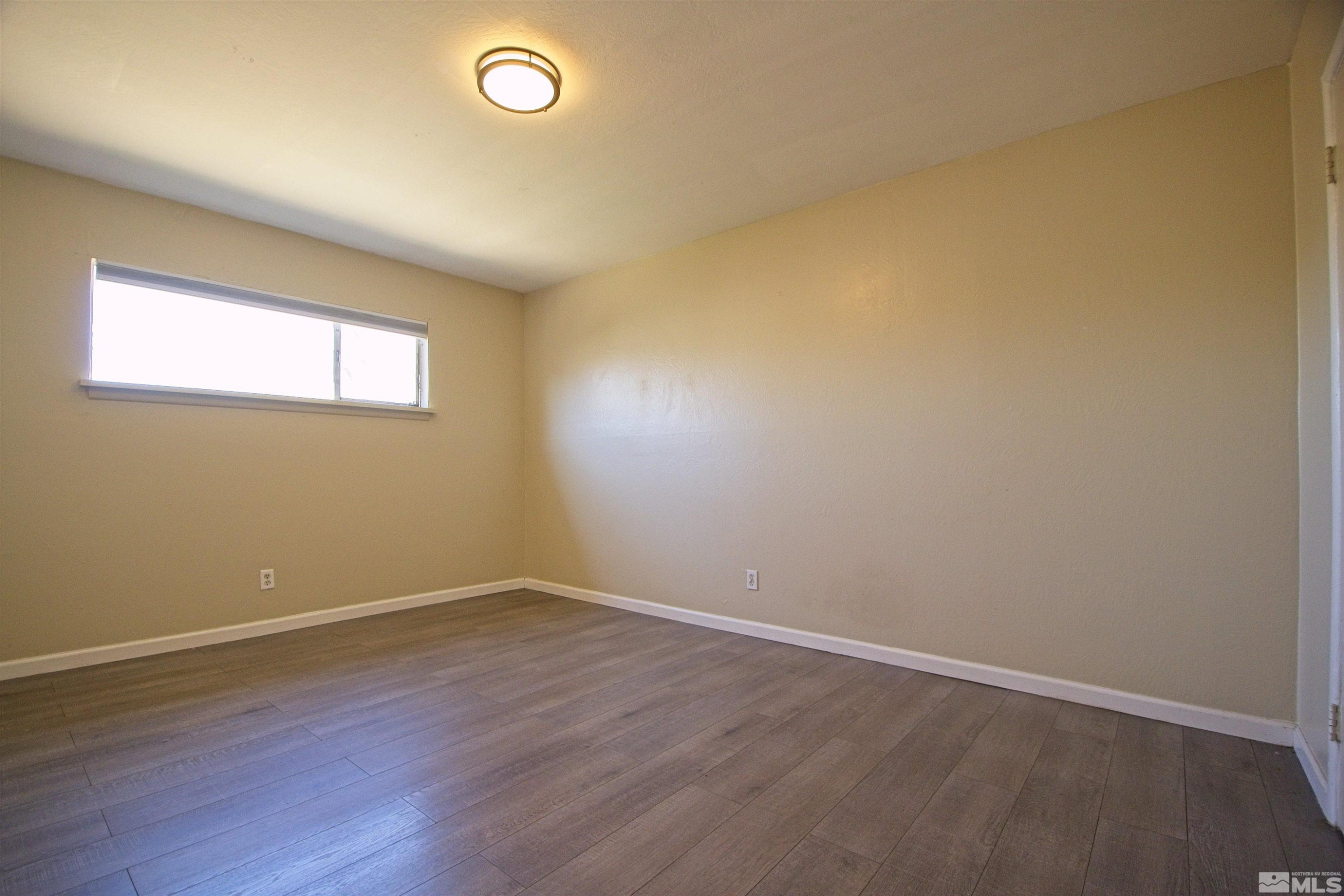 2516 D Street Sparks, NV 89431 - Photo 9 of 9 an empty room with wooden floor and windows