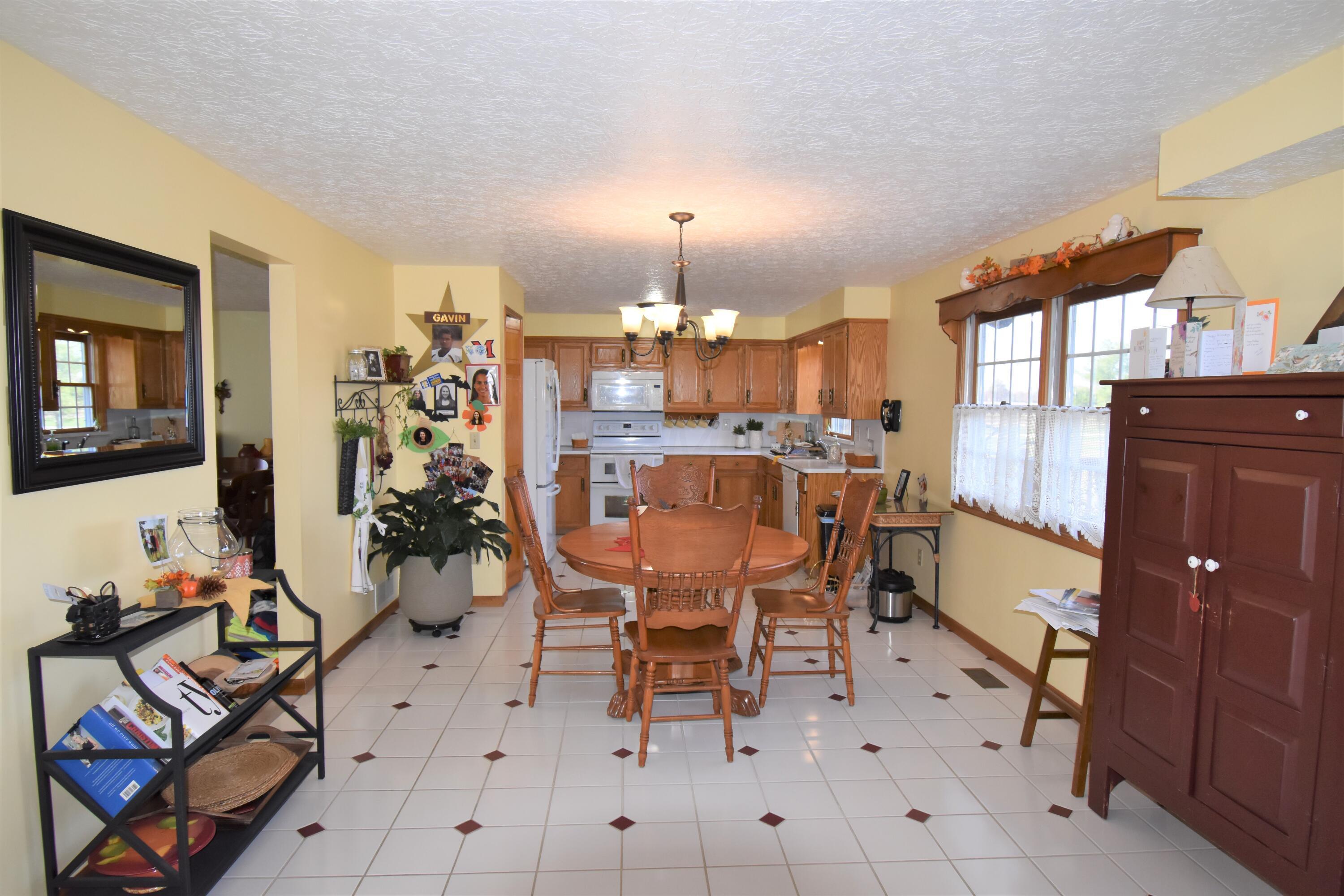 7680 Degood Road Ostrander, OH 43061 - Photo 7 of 42 19'0 x 12'0 Dinette eating area with ceramic flooring and door to rear deck.