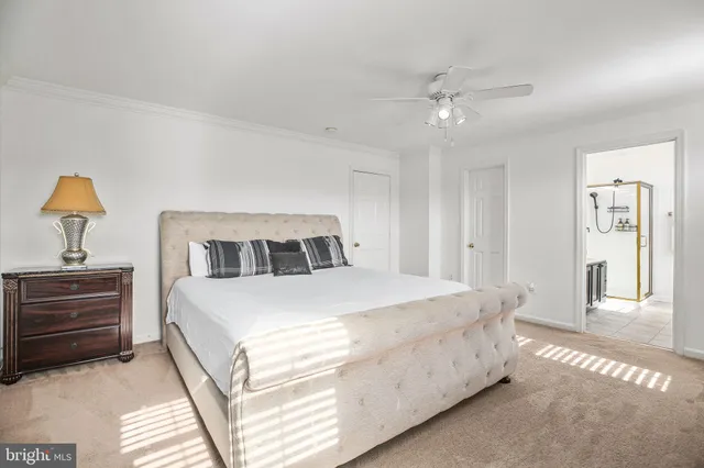 a bedroom with a large bed and a flat screen tv