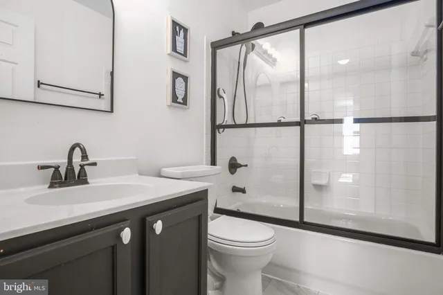 a bedroom with a bed a desk and chair