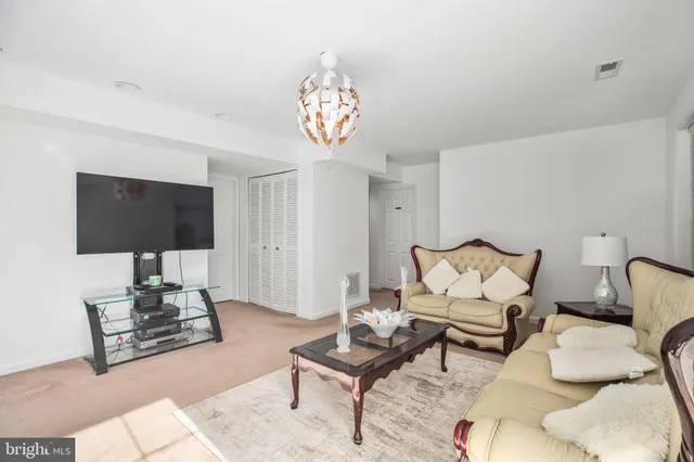 a bedroom with a bed couch and a flat tv screen