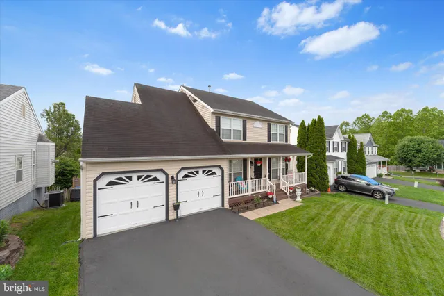 a view of a house with backyard porch and sitting area