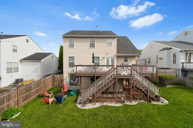 a view of a chair and table in backyard of the house