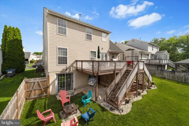 a view of a house with pool and a yard