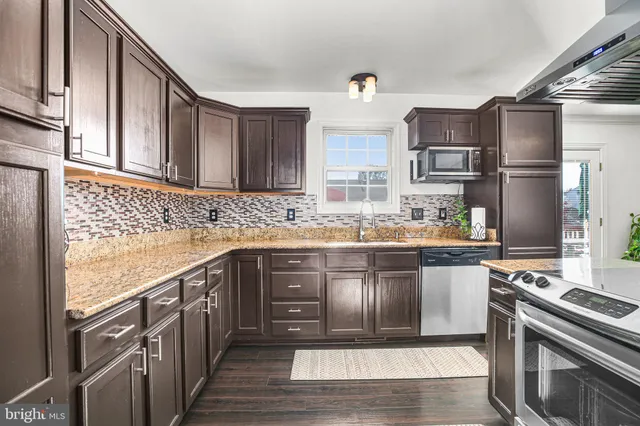 a view of a dining room with furniture and a chandelier