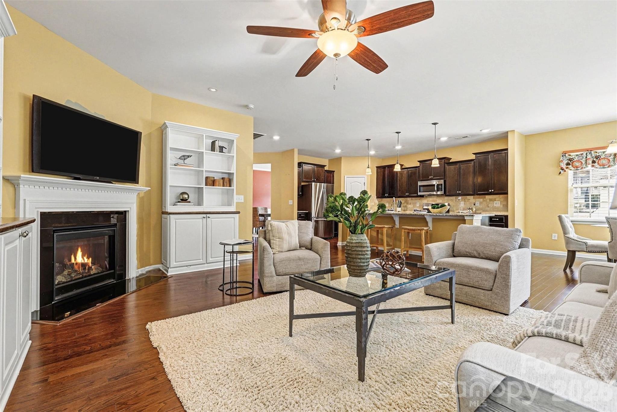 2192 Winhall Road Fort Mill, SC 29715 - Photo 11 of 32 a living room with furniture a flat screen tv and a fireplace