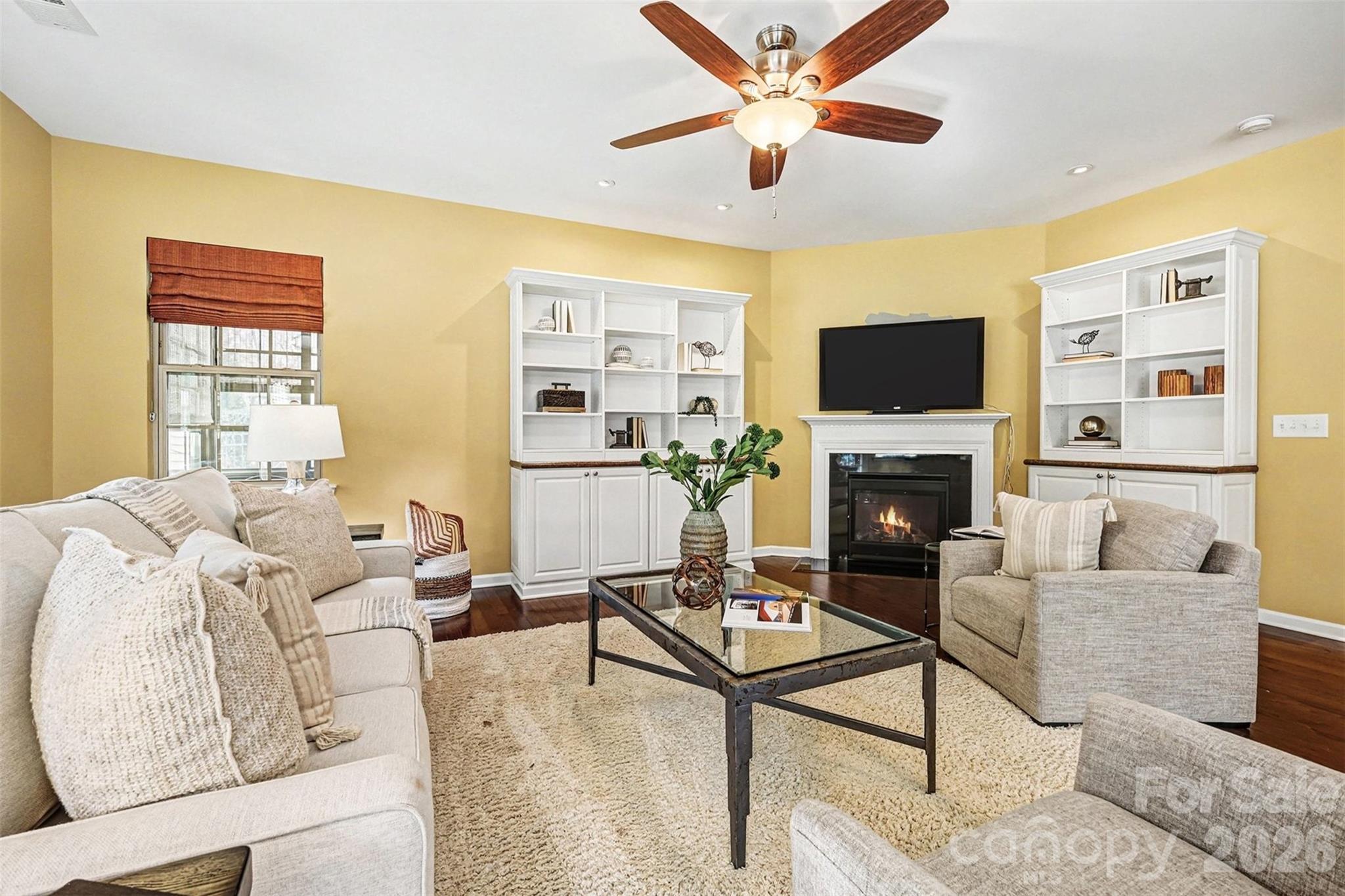 2192 Winhall Road Fort Mill, SC 29715 - Photo 13 of 32 a living room with furniture a flat screen tv and a fireplace