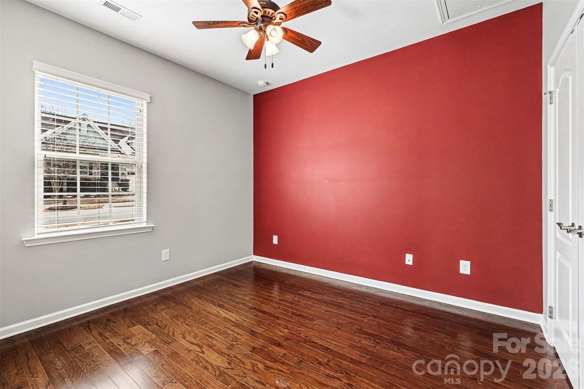 2192 Winhall Road Fort Mill, SC 29715 - Photo 21 of 32 a view of an empty room with a window and wooden floor