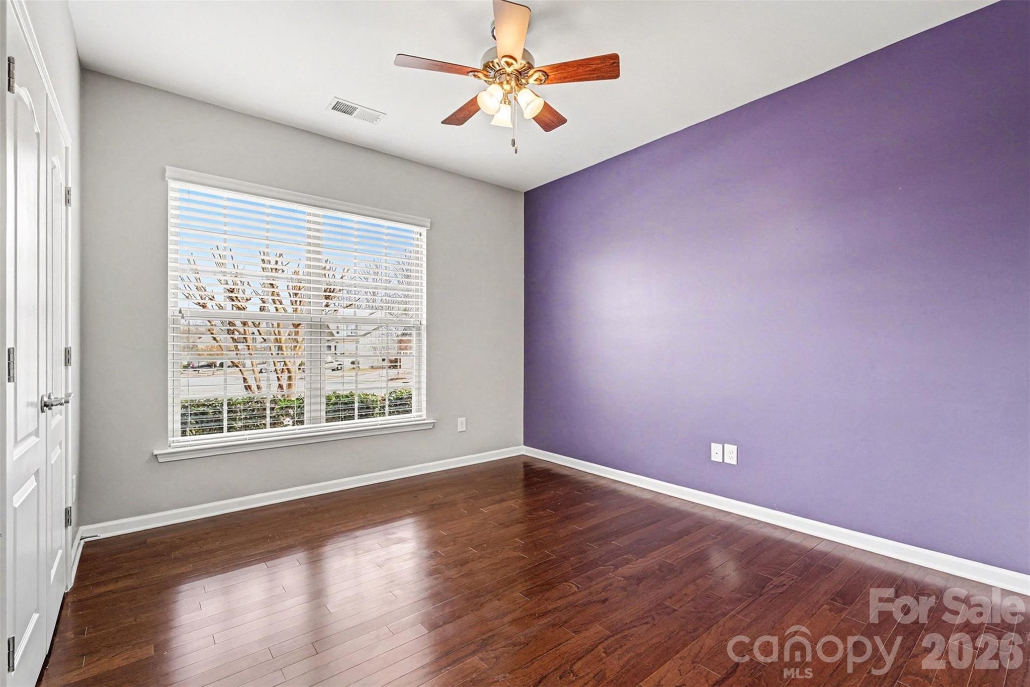 2192 Winhall Road Fort Mill, SC 29715 - Photo 22 of 32 an empty room with wooden floor and windows