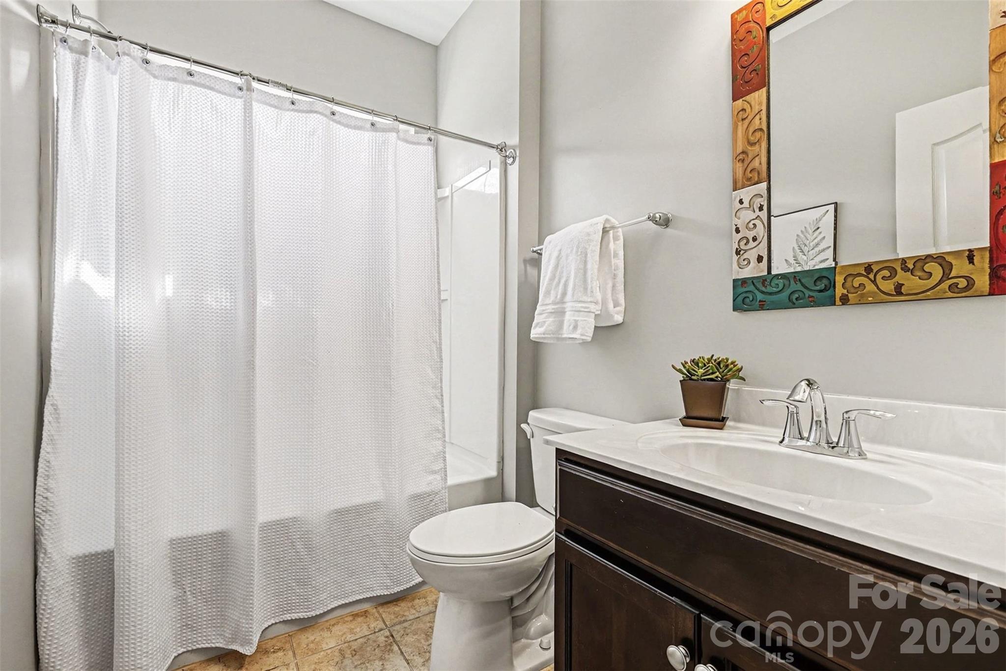 2192 Winhall Road Fort Mill, SC 29715 - Photo 23 of 32 a bathroom with a sink a toilet and shower curtain