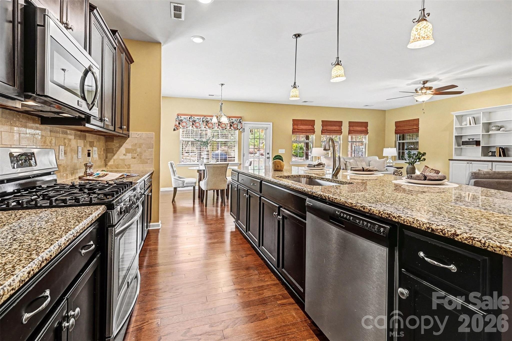 2192 Winhall Road Fort Mill, SC 29715 - Photo 6 of 32 a kitchen with stainless steel appliances granite countertop a stove a sink and a microwave