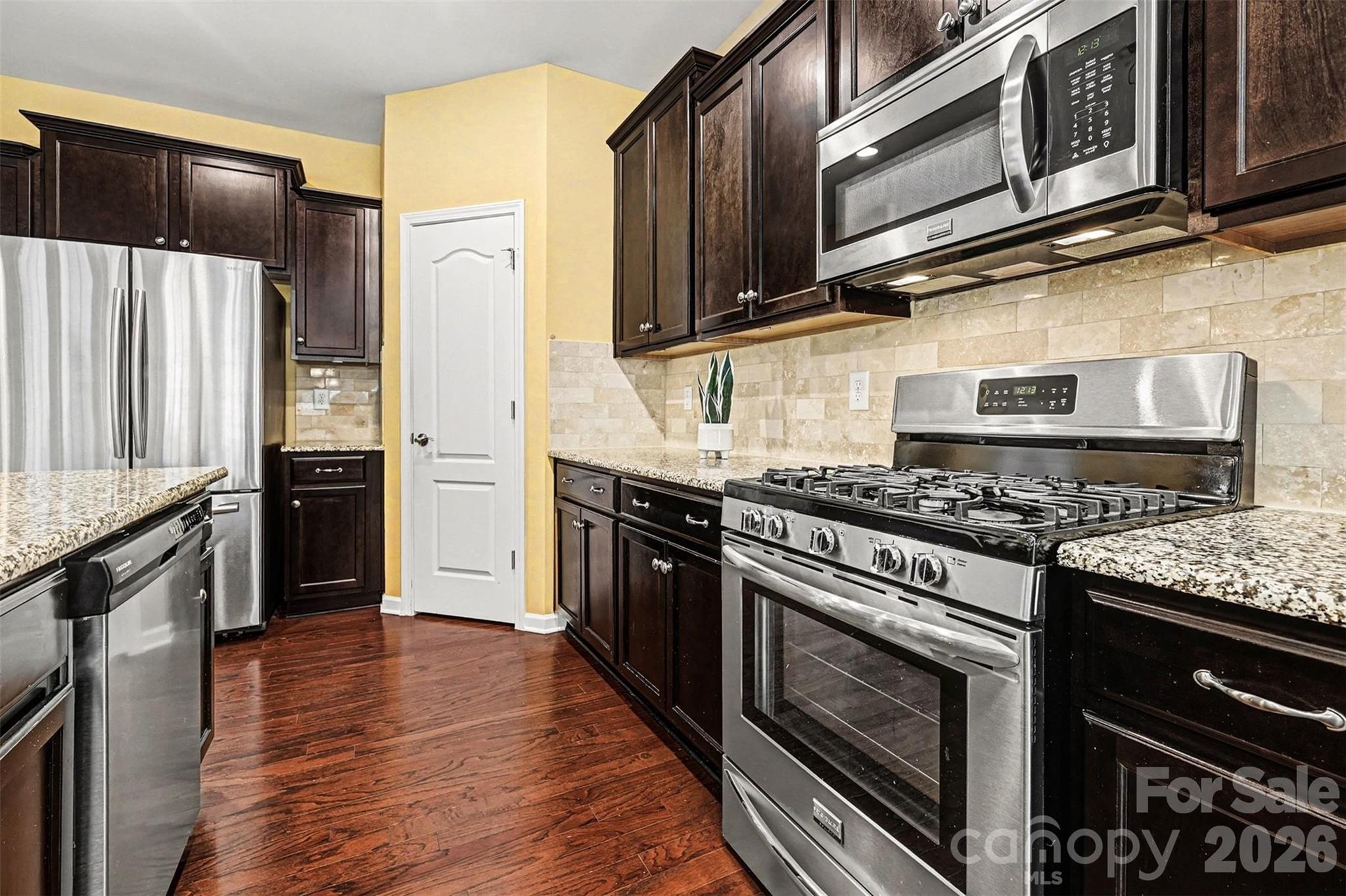 2192 Winhall Road Fort Mill, SC 29715 - Photo 7 of 32 a kitchen with stainless steel appliances granite countertop a stove and a microwave