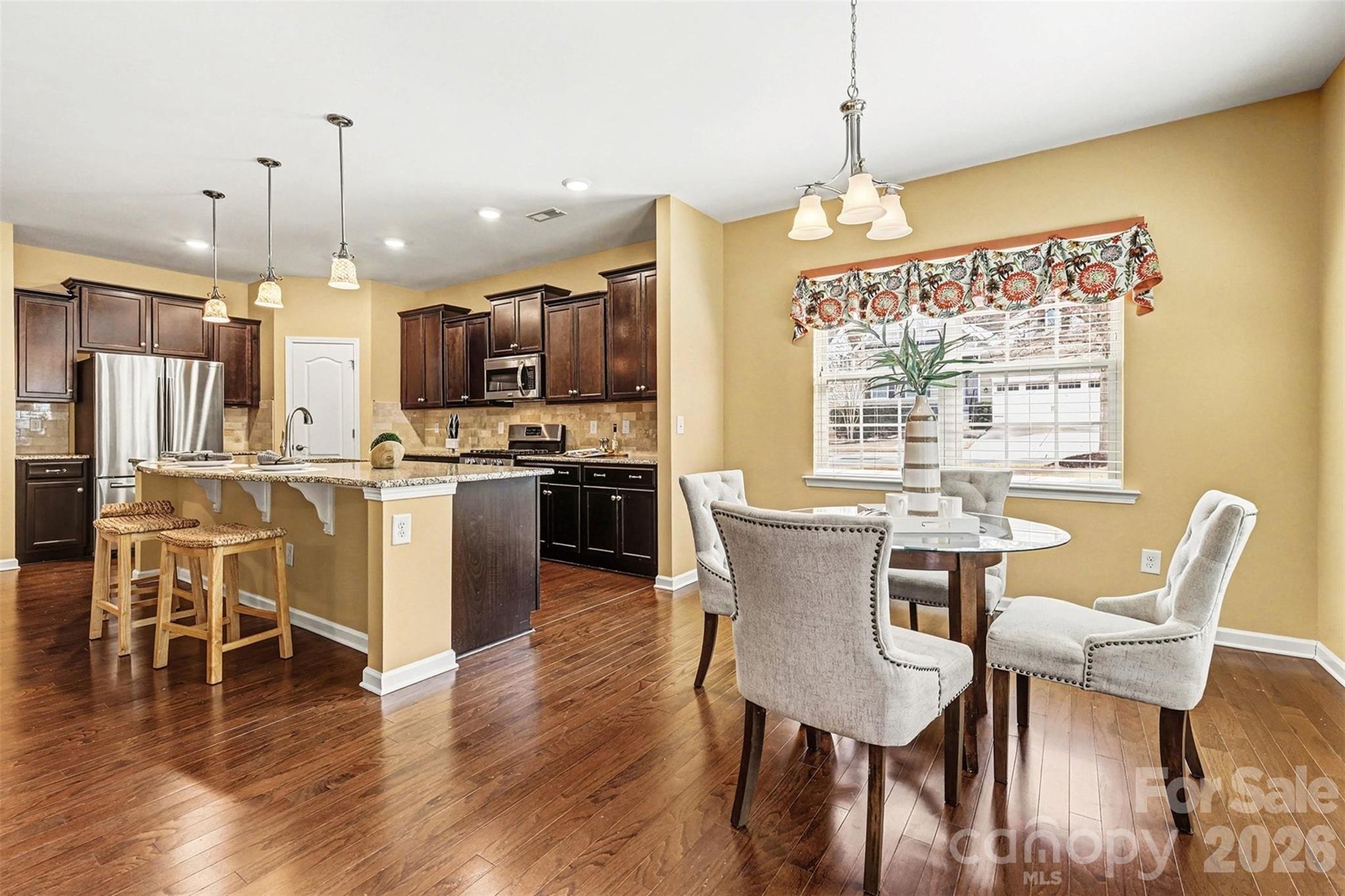 2192 Winhall Road Fort Mill, SC 29715 - Photo 9 of 32 a view of a dining room with furniture window and wooden floor