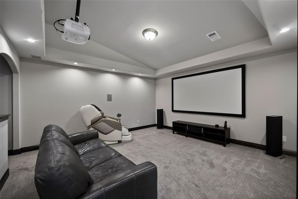1039 Stephen Street Allen, TX 75013 - Photo 28 of 40 Home theater room with recessed lighting, vaulted ceiling, carpet floors, and a raised ceiling