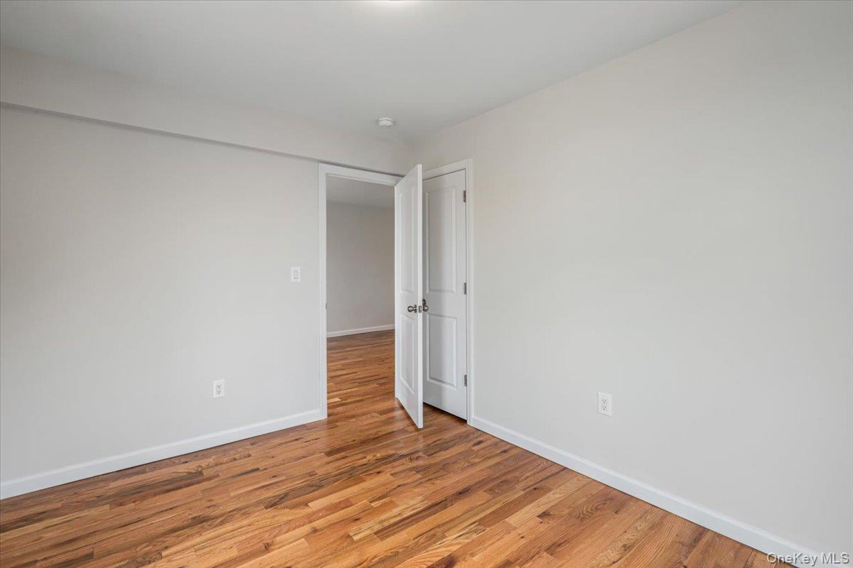 59-30 108th Street, Unit 6D Queens, NY 11368 - Photo 15 of 23 a view of an empty room with wooden floor