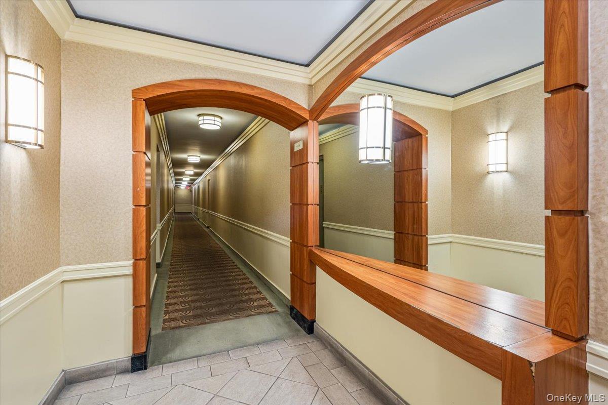 59-30 108th Street, Unit 6D Queens, NY 11368 - Photo 21 of 23 a hallway with sliding door and mirror