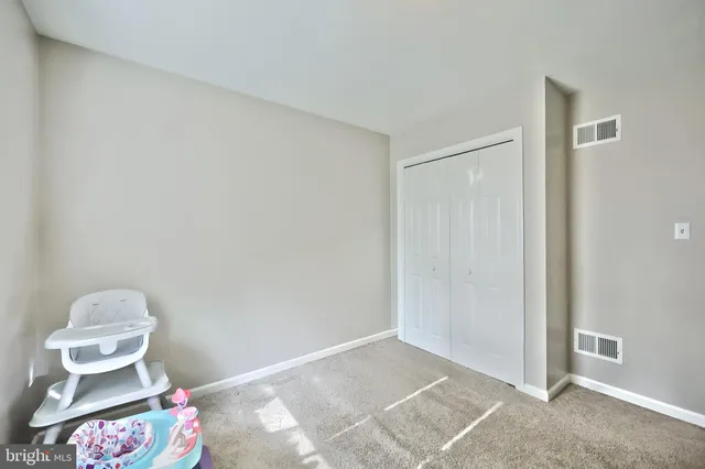 a view of a bedroom with furniture