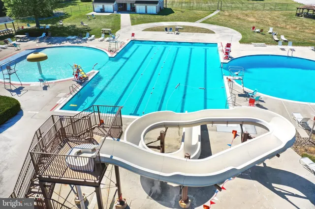 an aerial view of a house with a yard and lake view