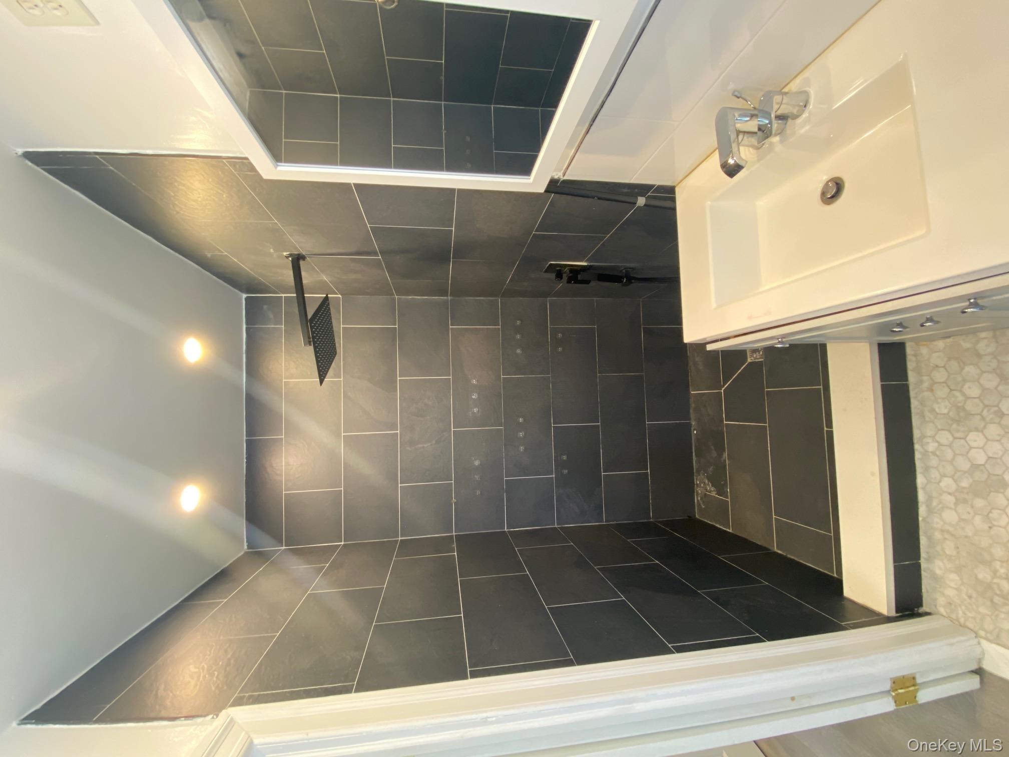 686 East 239th Street Bronx, NY 10470 - Photo 13 of 30 a bathroom with a bathtub and a shower
