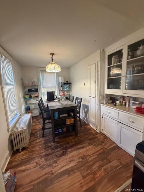 686 East 239th Street Bronx, NY 10470 - Photo 15 of 30 a kitchen with a dining table chairs and refrigerator