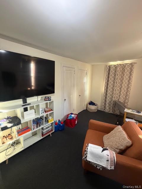 686 East 239th Street Bronx, NY 10470 - Photo 16 of 30 a living room with furniture and a flat screen tv