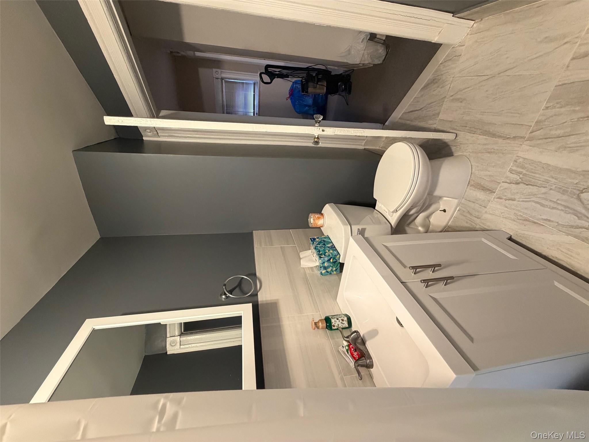 686 East 239th Street Bronx, NY 10470 - Photo 17 of 30 a white toilet sitting next to a bathroom sink