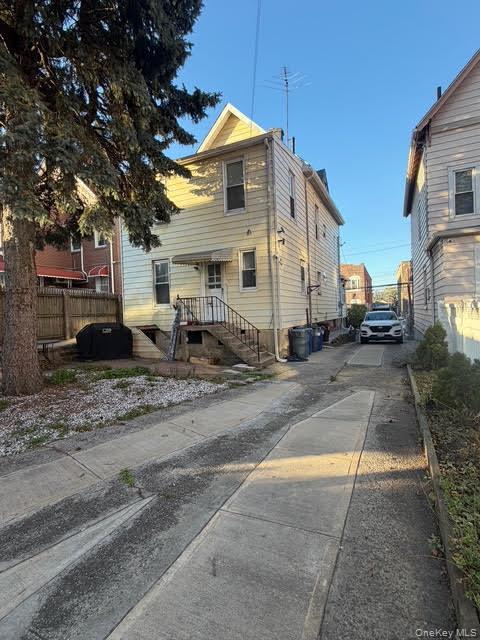 686 East 239th Street Bronx, NY 10470 - Photo 2 of 30 a front view of a house with cars parked